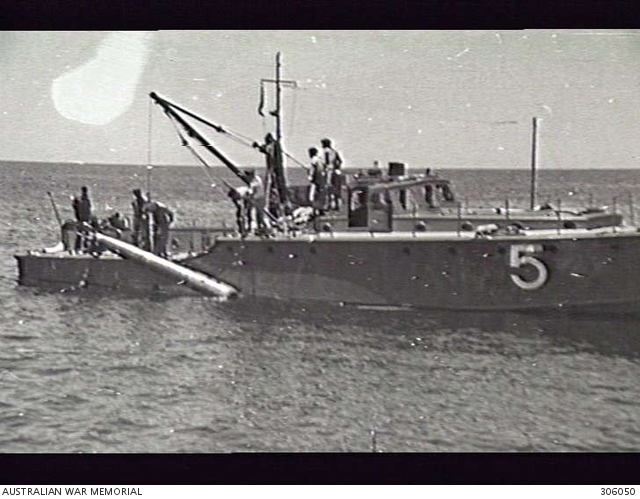 Torpedo Recovery vessel 03.5 hoisting in a Mark XII inch torpedo at 6 Operational Training Unit and Base Torpedo Unit. The vessel was one of the boats used by the Marine Section.