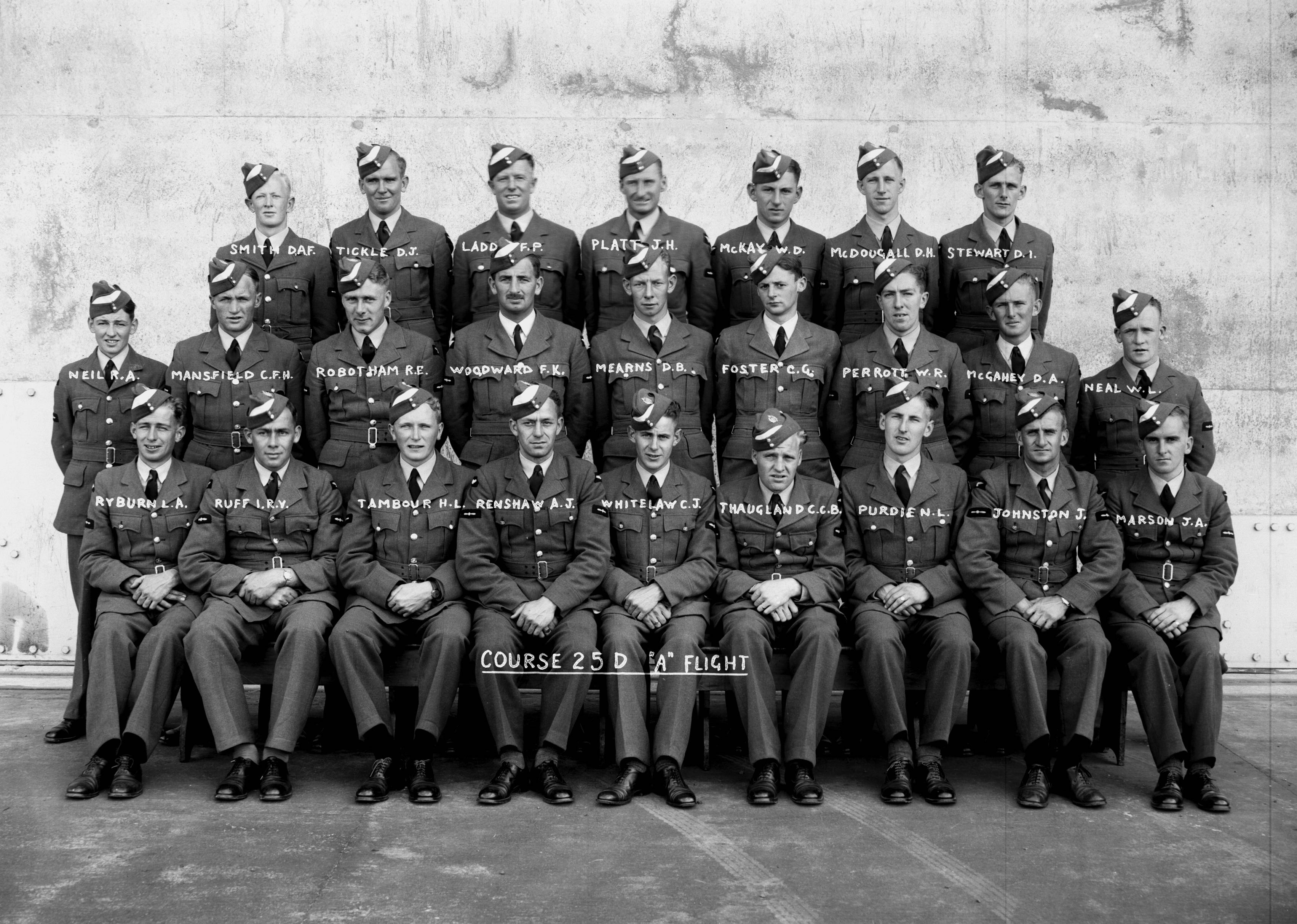 Tambour received his elementary flying training at 4 EFTS, RNZAF Station Whenuapai. The photo shows the ‘A’ Flight of the pilots course 25D, presumably at graduation in February 1942. In the back row are (left to right): D.A.F. Smith, D.J. Tickle, F.P. Ladd, J.H. Platt, W.D. McKay, D.H. McDougall, D.I. Stewart; In the middle row: R.A. Neil, C.F.H. Mansfield, R.E. Robotham, F.K. Woodward, D.B. Mearns, C.G. Foster, W.R. Perrott, D.A. McGahey, W.L. Neal; and in the front row: L.A. Ryburn, I.R.V Ruff, H.L. Tambour, A.J. Renshaw, C.J. Whitelaw, C.C.B. Thaugland, N.L. Purdie, J. Johnston, J.A. Marson. (Air Force Museum of New Zealand Photograph Collection).