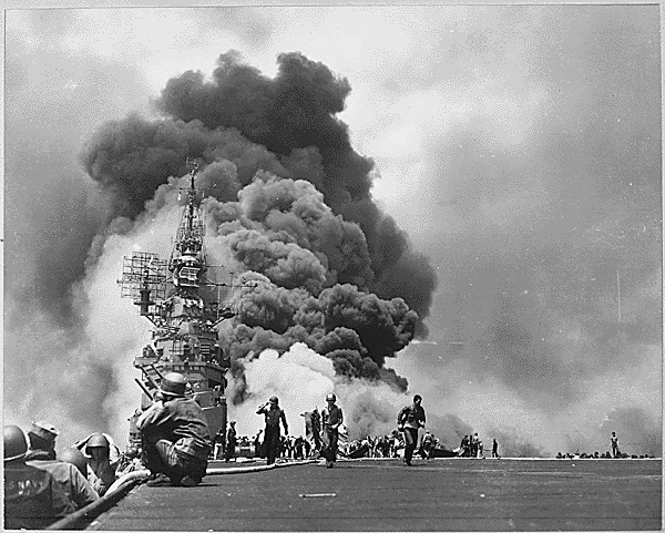 USS <em>Bunker Hill</em> hit by two Kamikazes in 30 seconds on 11 May 1945 off Kyushu. Dead-372. Wounded-264. (NARA, 520678)