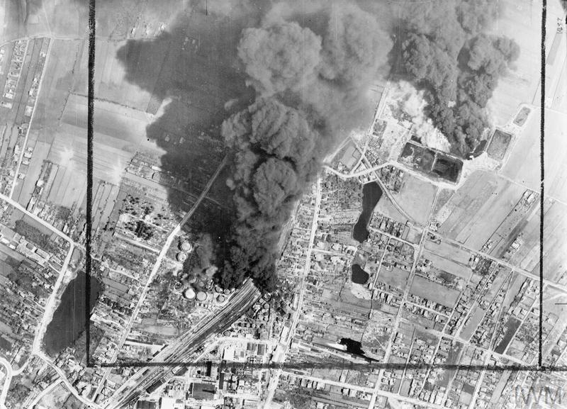 Vertical photographic-reconnaissance aerial taken over the oil refinery and marshalling yards at Campina, 20 miles north-west of Ploesti, Romania, following an early morning attack by Handley Page Halifaxes and Vickers Wellingtons of No. 205 Group RAF. Smoke from burning oil tanks is drifting over the target area, which was also attacked by Consolidated Liberators of the 15th USAAF, half and hour after this photograph was taken. It is not certain, that this was the operation, Høyer participated in on 5/6 May 1944. &copy IWM (C 4346).