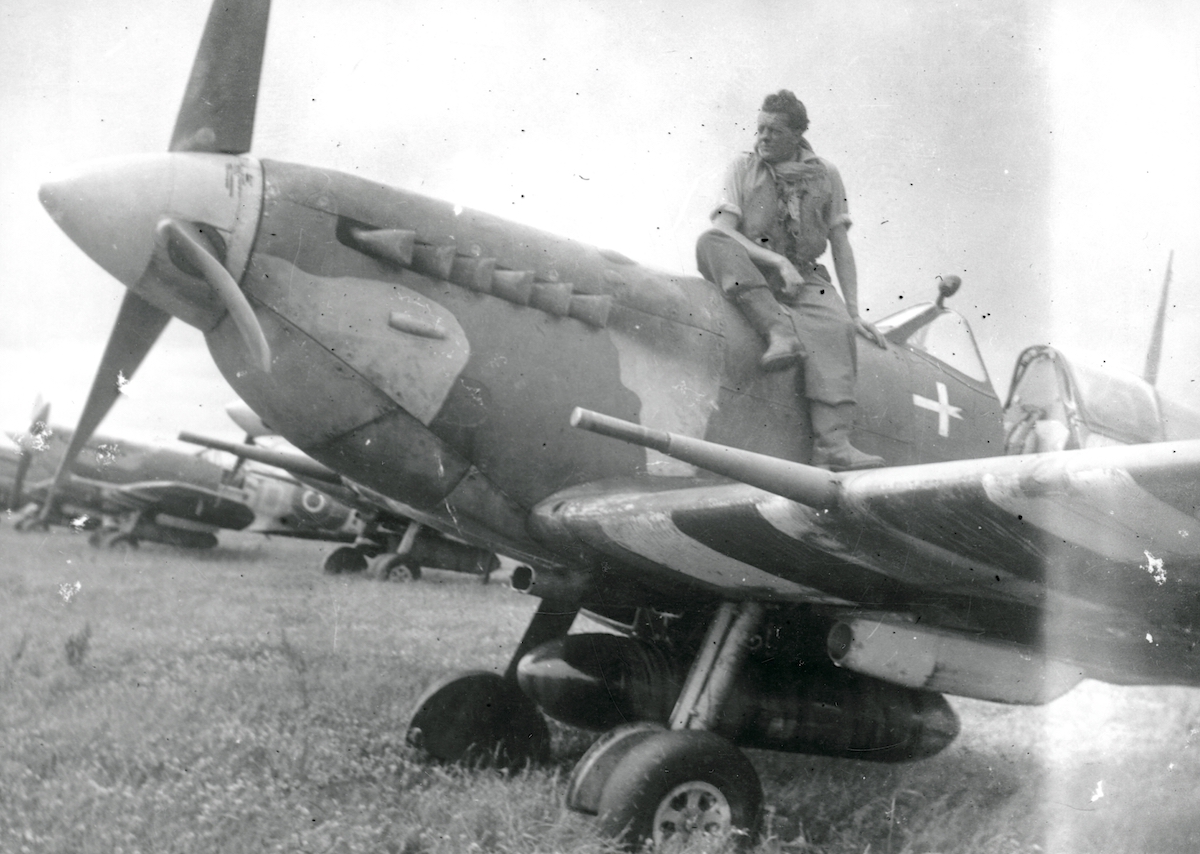 Fg Off. Jørgen Kjeldbæk sitting on the cowling of a Spitfire V; presumably Spitfire Vb AB989/SD-C, which he flew on D-Day. © Museum of Danish Resistance.
