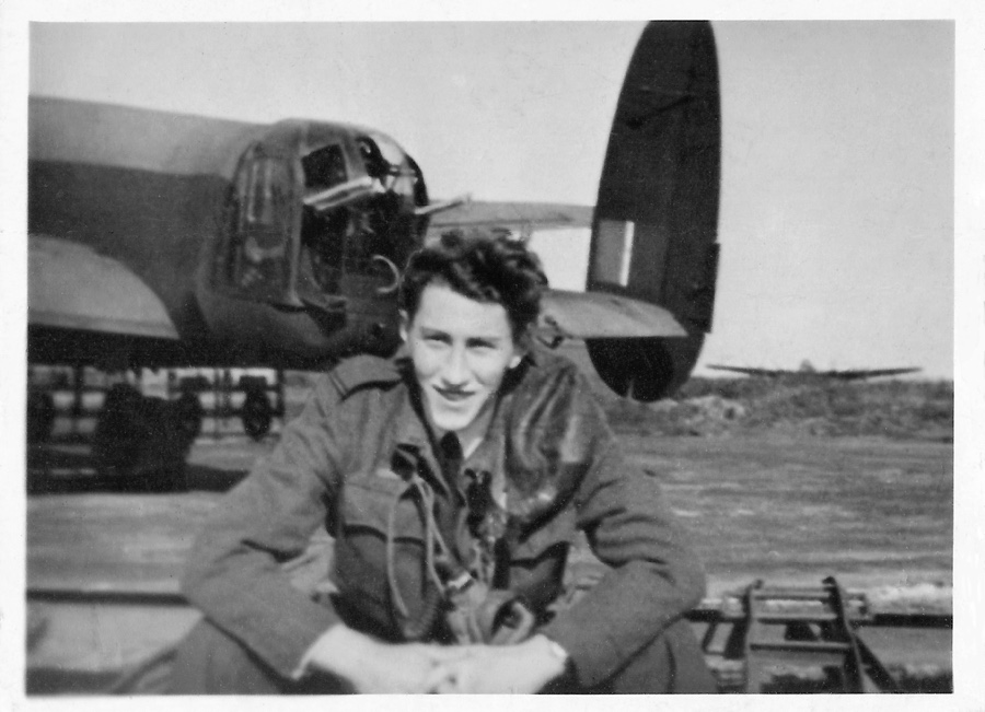 Fg Off. Niels Erik Westergaard, DFC, sitting in front of a Lancaster at an unknown air station. (Author’s collection)