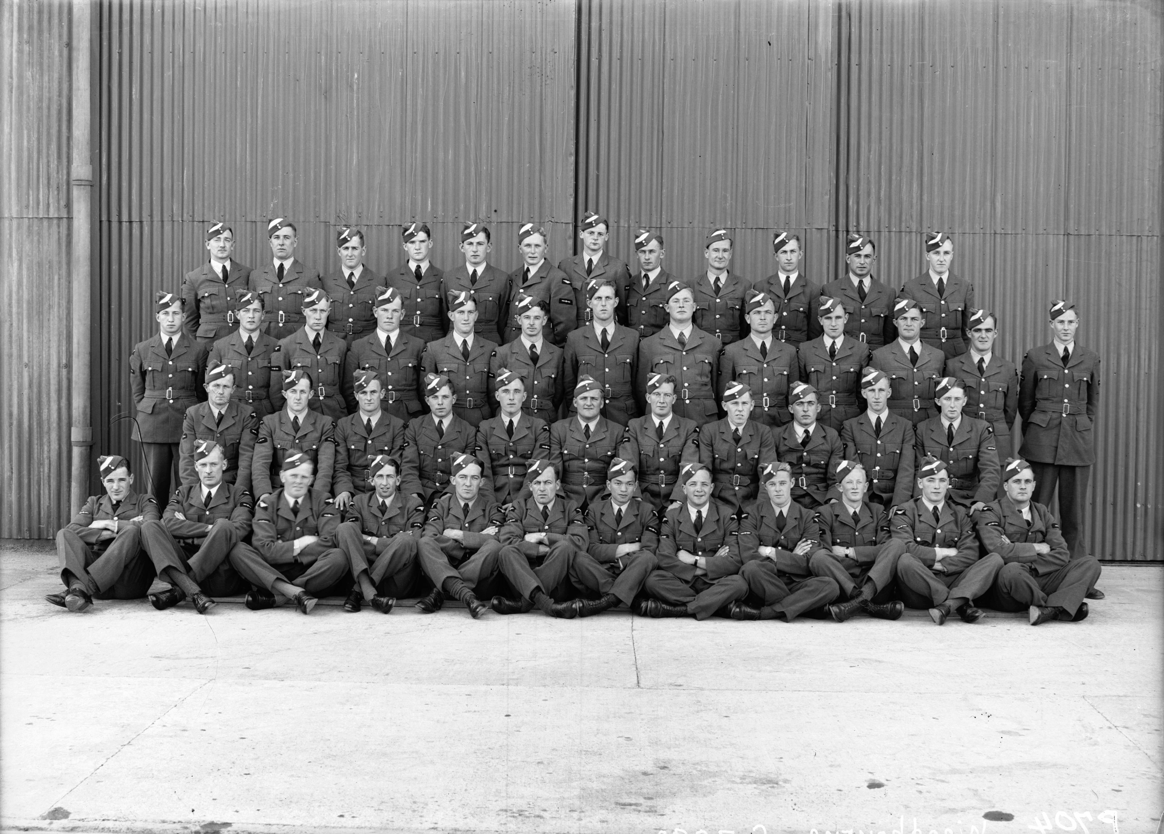 Tambour was transferred to 2 SFTS, RNZAF Station Woodbourne in March 1942, when 3 SFTS was disbanded. The photo shows Course No. 25B. In the back row are (left to right): Lumsden, Tanner, Parsons, Blue, McKay, Tambour, Foster, Stringer, Collins, Anderson, Rimmer, McCabe; in the third row: Gray, Sutherland, Keller, Tennant, Howie, Cole, East, Broun, Regan, Alexander, Elliot, Graham, Towgood; in the second row: Donnelly, Bunt, Abbot, Bills, Mooney, Hambrook, Pearson, Swan, Rutherford, McDougall, Craig; and in the front row: Rendall, Webb, Williams, P Smith, Reid, Meagher, Lee, McDonald, Arkinstall, D Smith, Casey, Robins (Air Force Museum of New Zealand Photograph Collection).